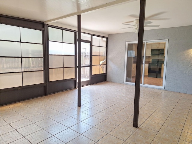 unfurnished sunroom with ceiling fan