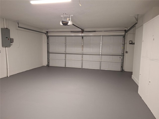 garage with electric panel and a garage door opener