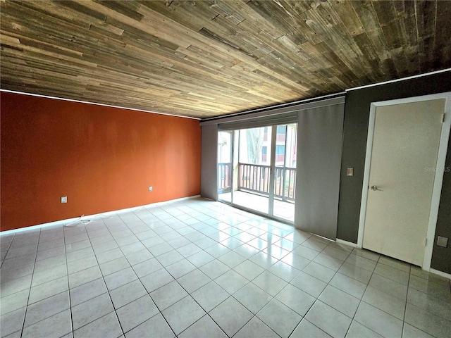 empty room featuring light tile patterned flooring, wood ceiling, and ornamental molding