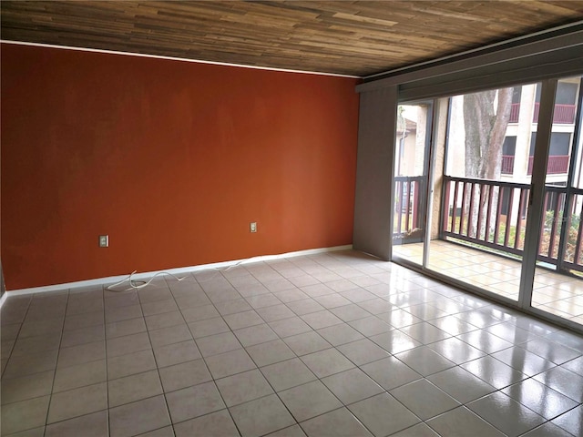 unfurnished room featuring light tile patterned floors and wooden ceiling