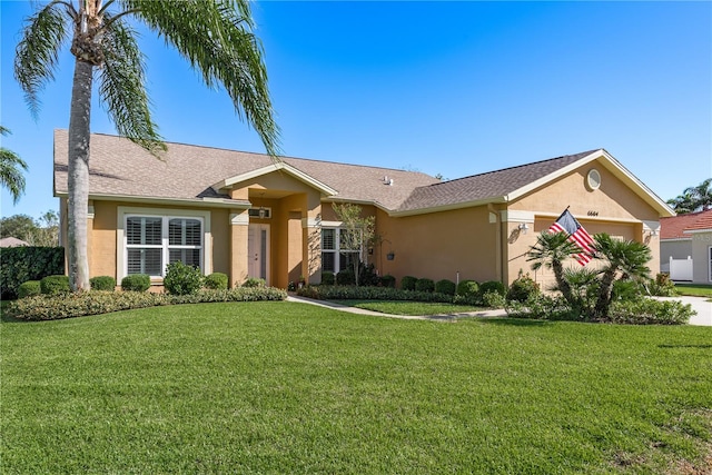 ranch-style house featuring a front yard and a garage