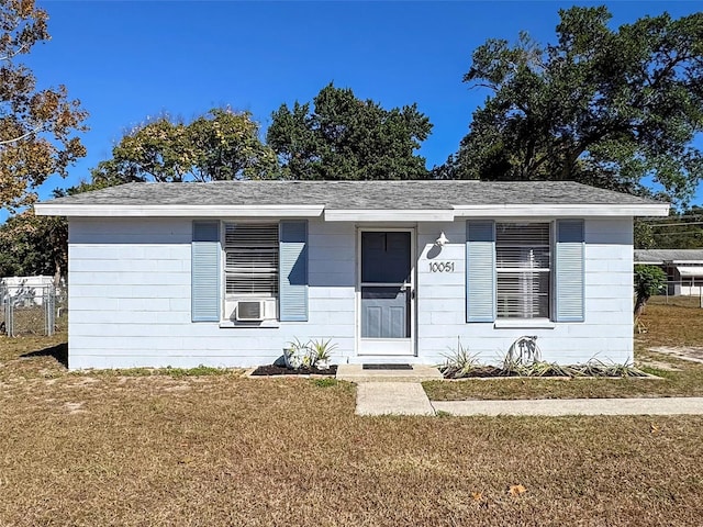 view of front of home with cooling unit and a front lawn