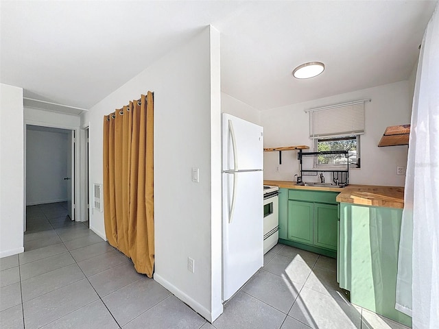 kitchen with green cabinets, light tile patterned floors, wooden counters, and white appliances