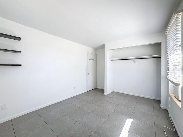 unfurnished bedroom featuring a closet and tile patterned flooring