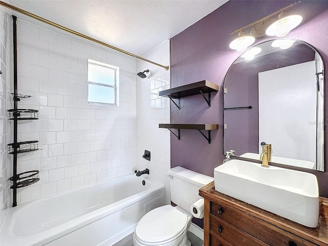 full bathroom with vanity, toilet, and tiled shower / bath