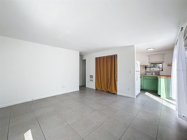 unfurnished living room featuring light tile patterned floors