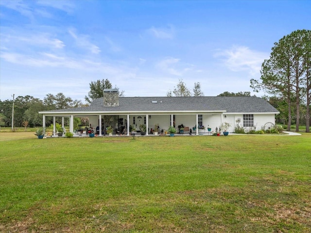 rear view of property with a yard