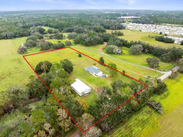 birds eye view of property featuring a rural view