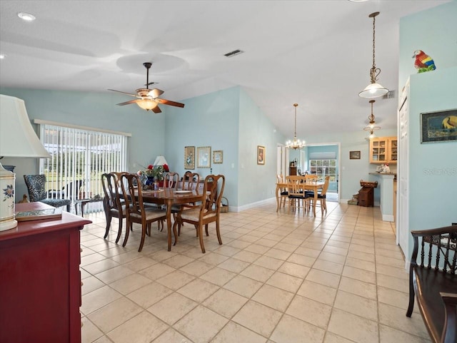 tiled dining room featuring high vaulted ceiling and ceiling fan with notable chandelier