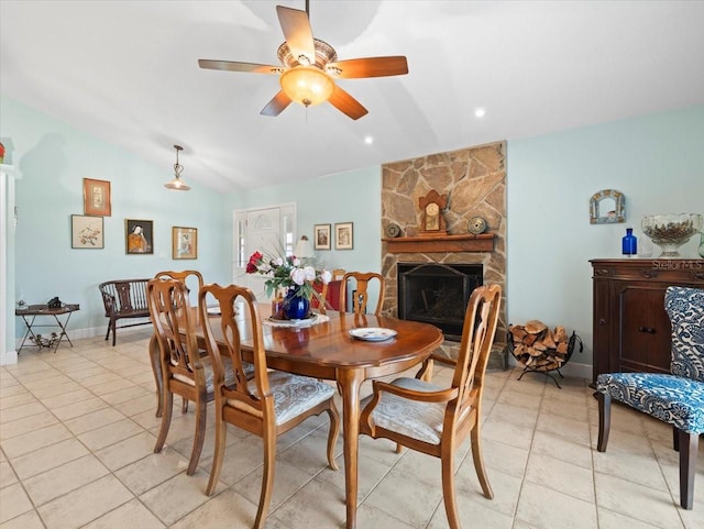 dining space with ceiling fan, a fireplace, light tile patterned flooring, and lofted ceiling