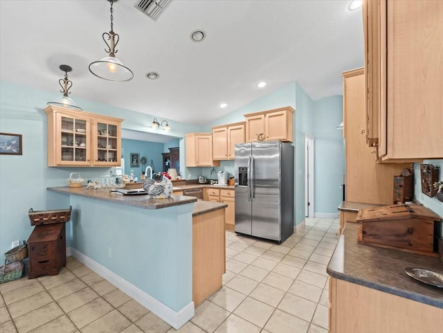 kitchen featuring stainless steel appliances, kitchen peninsula, pendant lighting, lofted ceiling, and light brown cabinetry