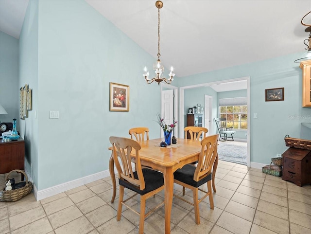 dining area featuring light tile patterned flooring, a chandelier, and vaulted ceiling