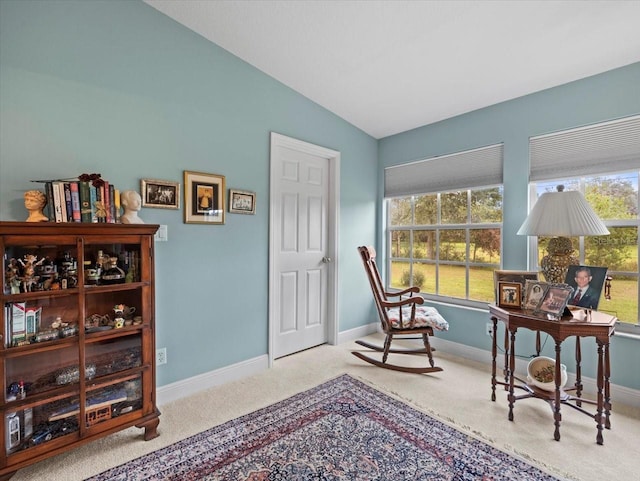 sitting room featuring light carpet and lofted ceiling