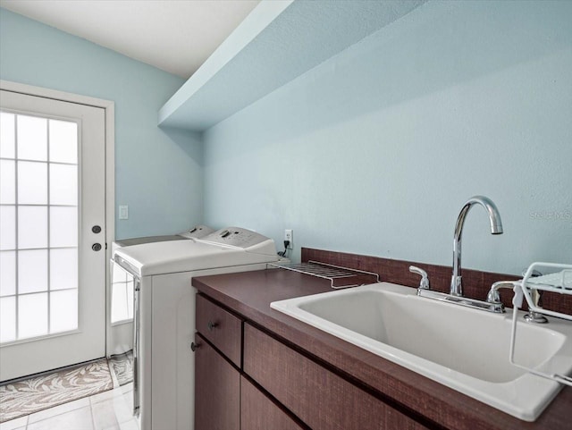 laundry room featuring washer and dryer, light tile patterned floors, cabinets, and sink