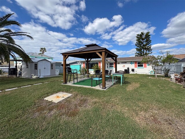 view of yard with a gazebo and a storage unit