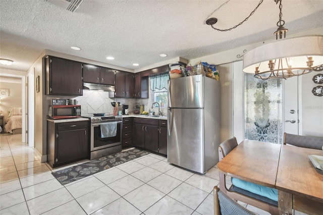 kitchen with dark brown cabinets, a textured ceiling, stainless steel appliances, pendant lighting, and a chandelier