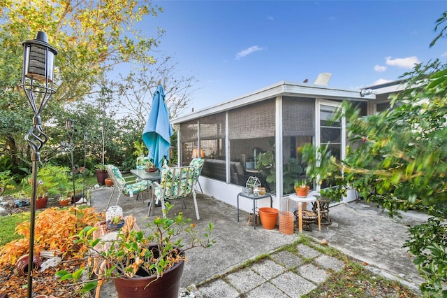 view of patio / terrace featuring a sunroom