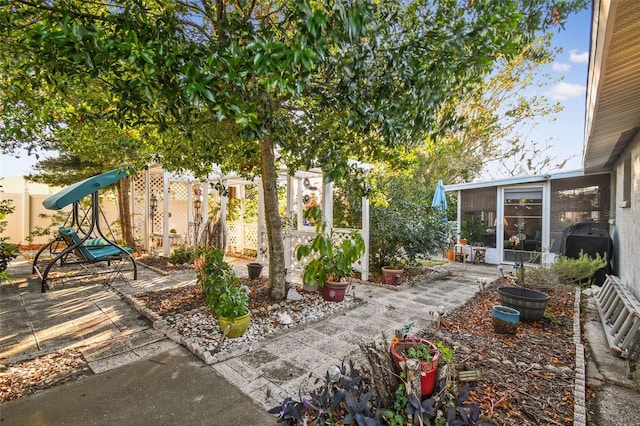 view of patio with a sunroom