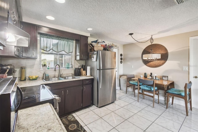 kitchen with sink, a textured ceiling, range hood, dark brown cabinets, and stainless steel appliances