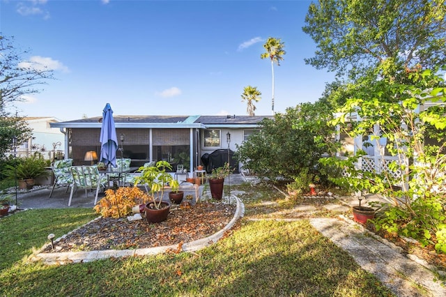 rear view of property featuring a yard and a patio