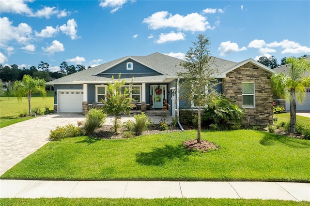 view of front of house with a front yard and a garage