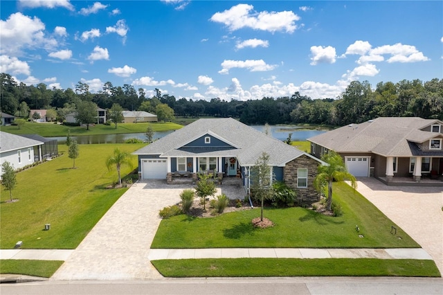 view of front facade featuring a porch, a garage, a water view, and a front yard