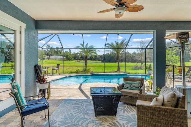 view of pool featuring a patio, ceiling fan, and a lanai