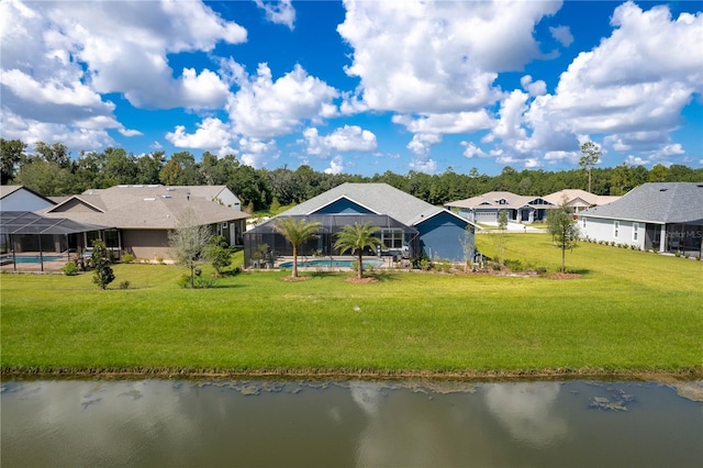 back of property with a lawn, a lanai, and a water view