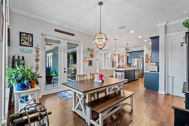 dining space with french doors, dark wood-type flooring, and ornamental molding