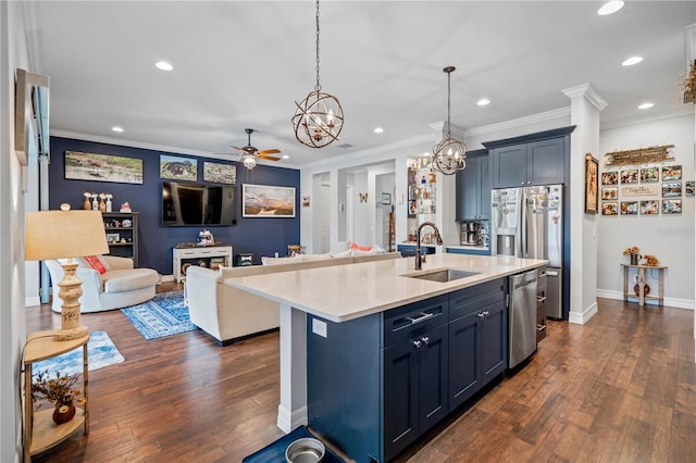 kitchen featuring pendant lighting, a center island with sink, sink, ceiling fan, and stainless steel appliances