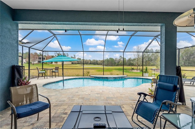 view of pool with glass enclosure and a patio area