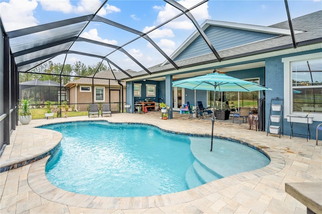 view of swimming pool with a patio and glass enclosure