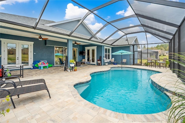 view of swimming pool with ceiling fan, a lanai, a patio, and french doors