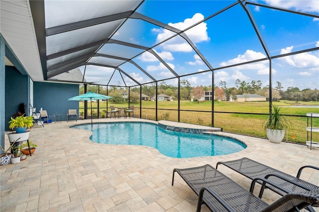 view of swimming pool with glass enclosure, a patio area, and a yard