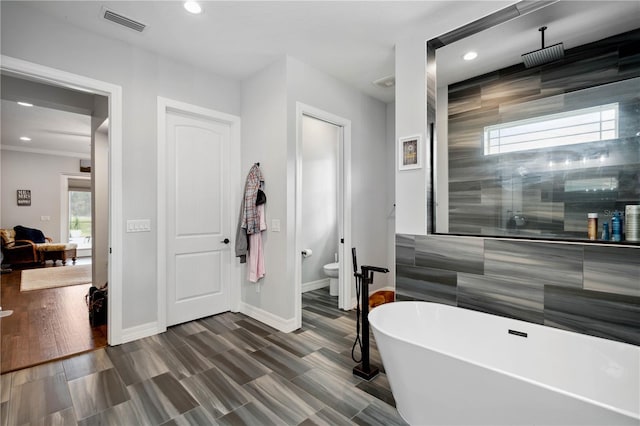 bathroom featuring ornamental molding and independent shower and bath