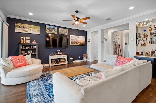 living room featuring dark hardwood / wood-style floors, ceiling fan, crown molding, and bar area