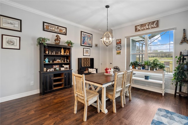 dining area with crown molding, dark hardwood / wood-style flooring, and an inviting chandelier