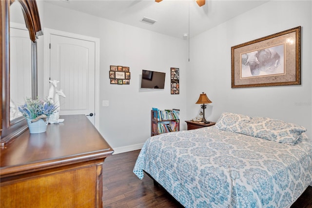 bedroom with ceiling fan and dark wood-type flooring