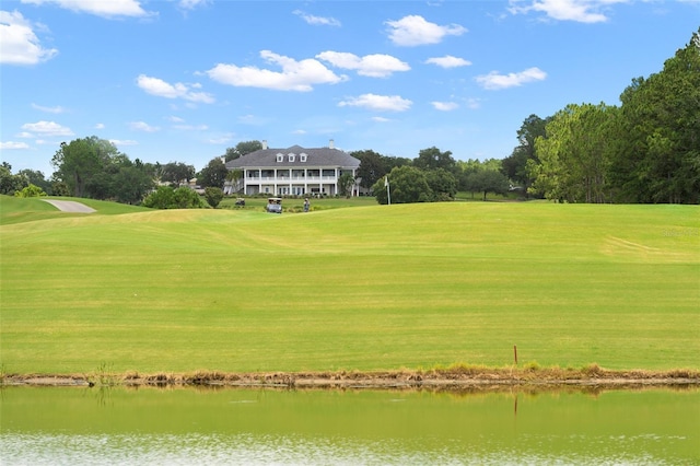 view of property's community featuring a yard and a water view