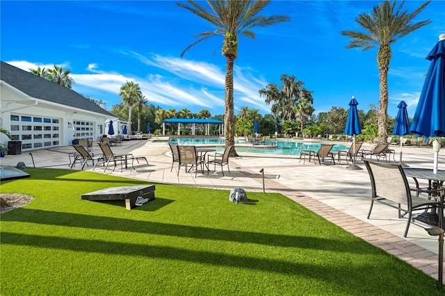 view of pool with a yard and a patio