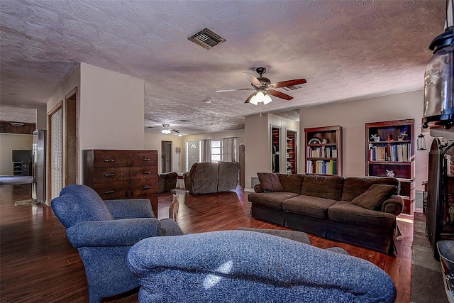 living room featuring a textured ceiling, dark hardwood / wood-style floors, and ceiling fan