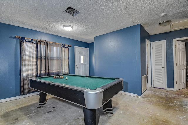 recreation room with a textured ceiling, concrete floors, and billiards