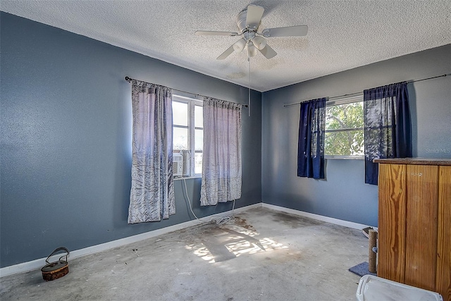 unfurnished room featuring a textured ceiling, concrete floors, and ceiling fan