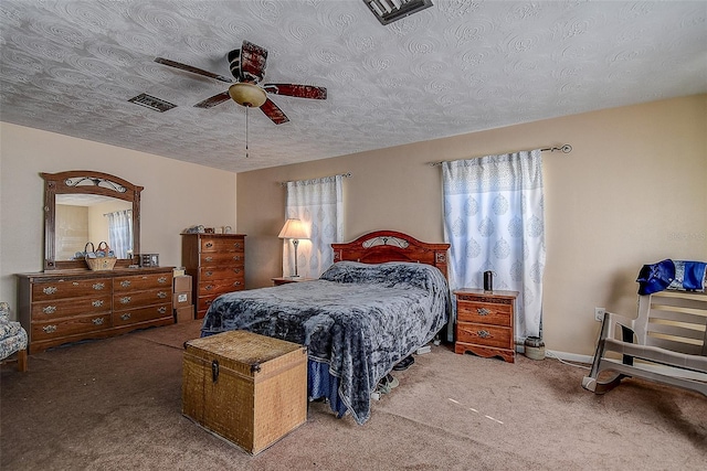 bedroom with carpet flooring, a textured ceiling, and ceiling fan