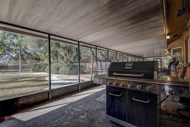 sunroom / solarium featuring lofted ceiling