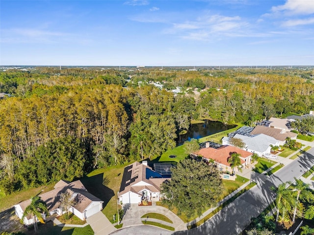 bird's eye view with a forest view and a water view