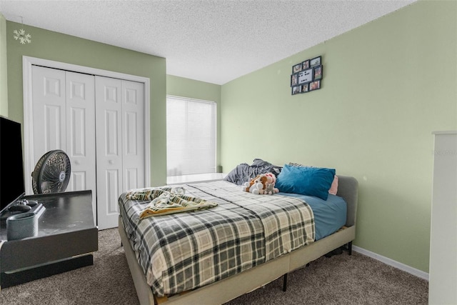 carpeted bedroom featuring a closet, a textured ceiling, and baseboards