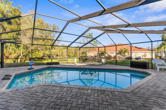 pool with a lanai and a patio area