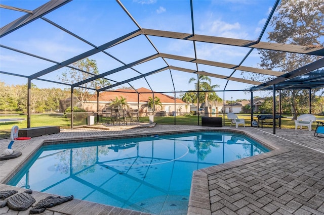 outdoor pool featuring a patio area and glass enclosure