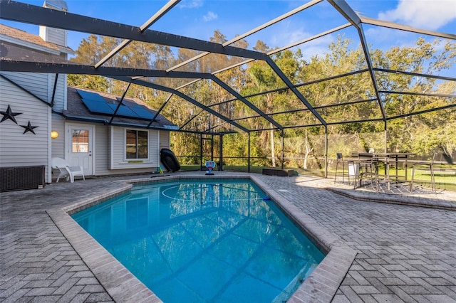 outdoor pool with a patio area and a lanai